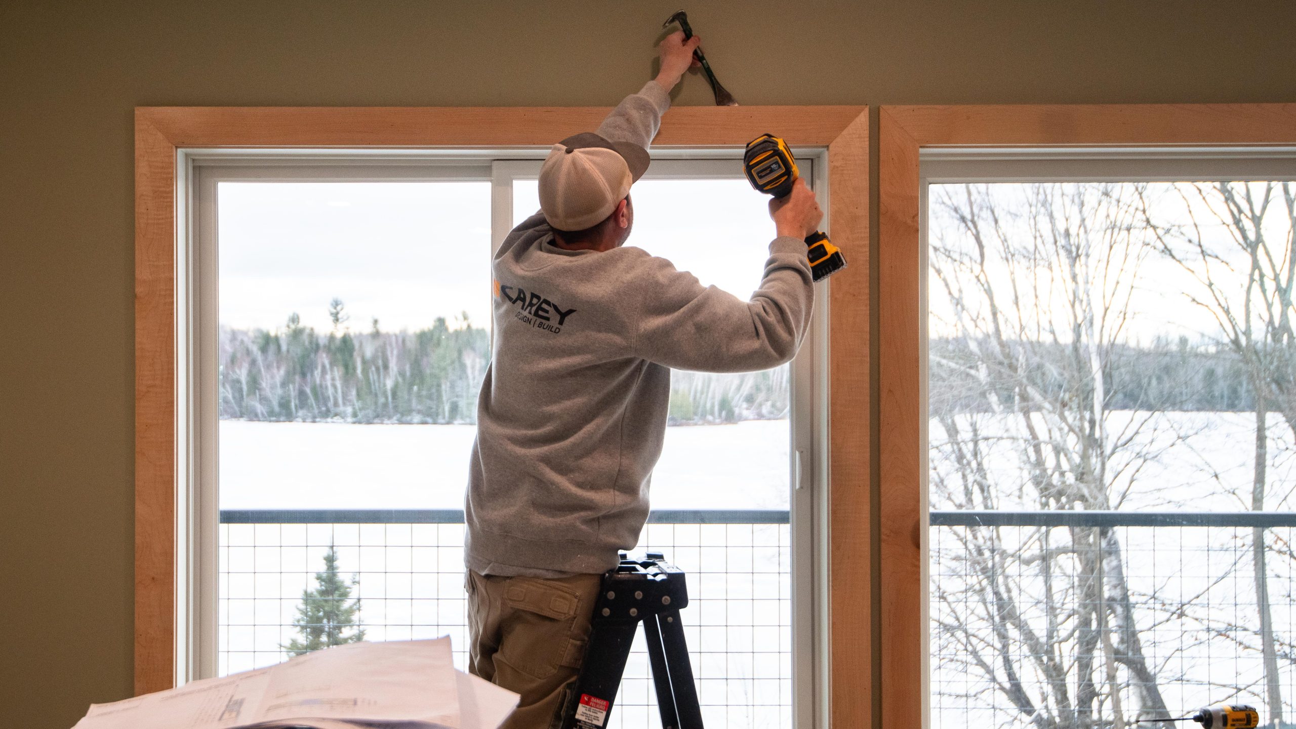 carpenter working on window trim, carpenter working indoors, winter work